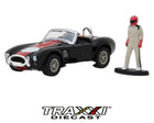 GreenLight 1965 Shelby Cobra 427 S/C 1:64 scale diecast side view in black with red stripe and side-exit exhaust.