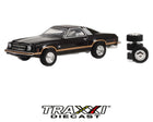 GreenLight 1:64 1976 Chevrolet Chevelle Laguna S3 black coupe with gold accent striping and included spare tire accessories front three-quarter view