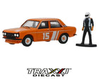 1970 Datsun 510 Sedan race car in orange with number 15 graphics and included racing driver figure from GreenLight Hobby Shop Series 7