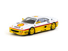 Tarmac Works Ferrari F355 Challenge 1999 #82 Shell livery 1:64 diecast front three-quarter view showing yellow wheels and detailed race graphics.